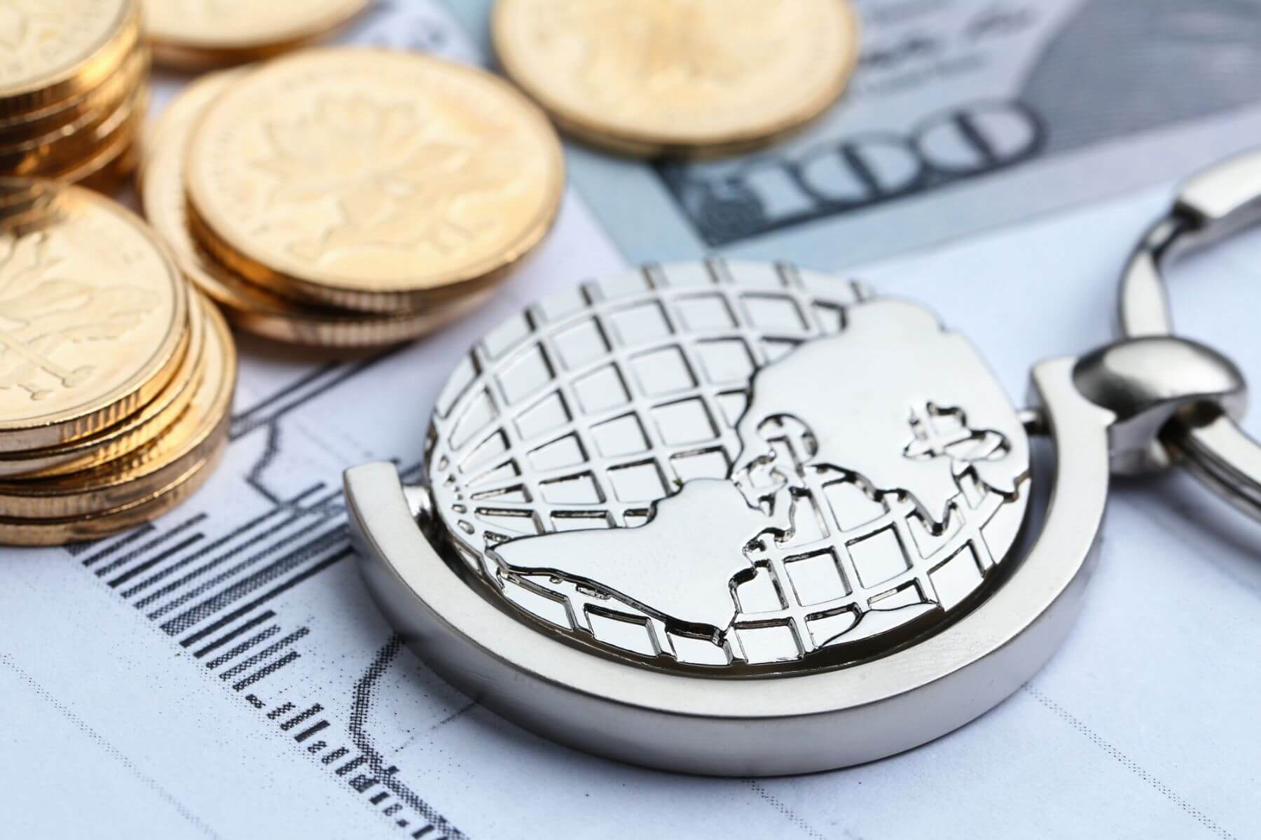 coins and a metal globe on a table
